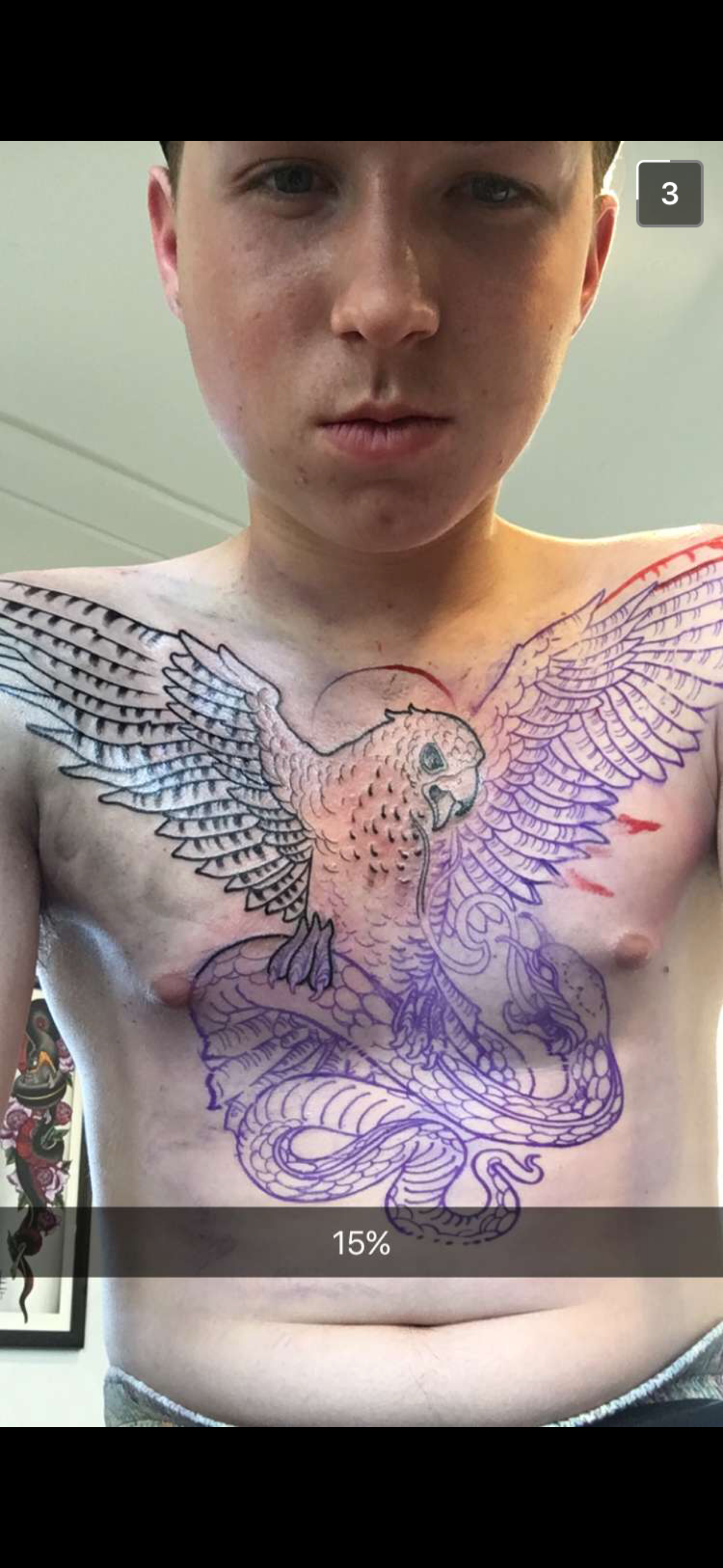 Stone showing his chest tattoo