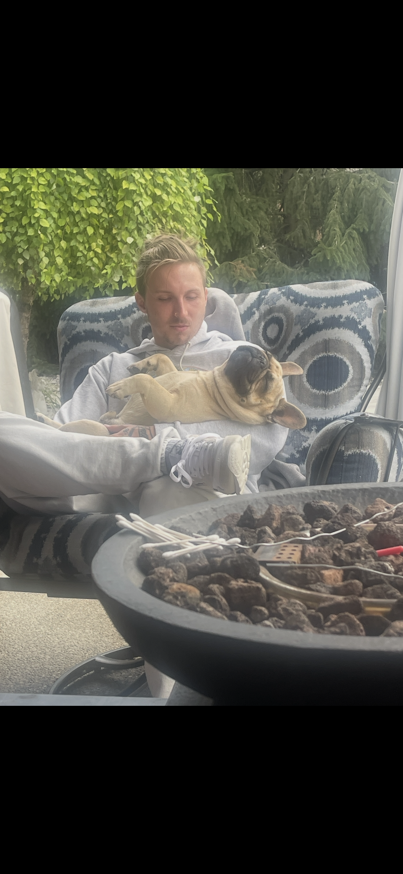 Stone with his dog by the firepit