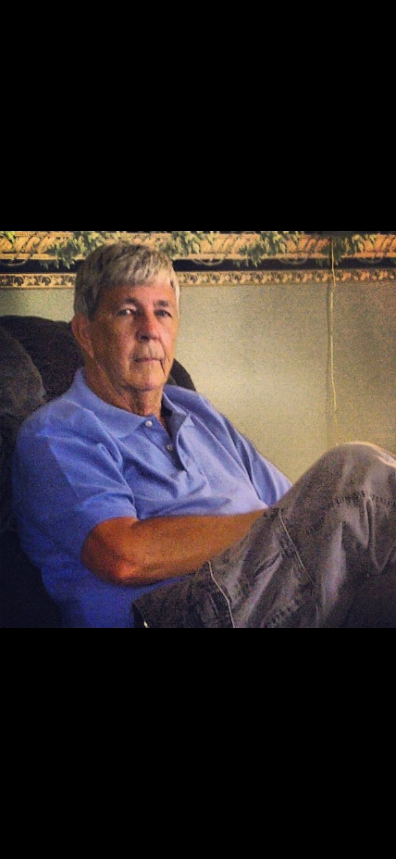 Stone's grandfather relaxing in a chair