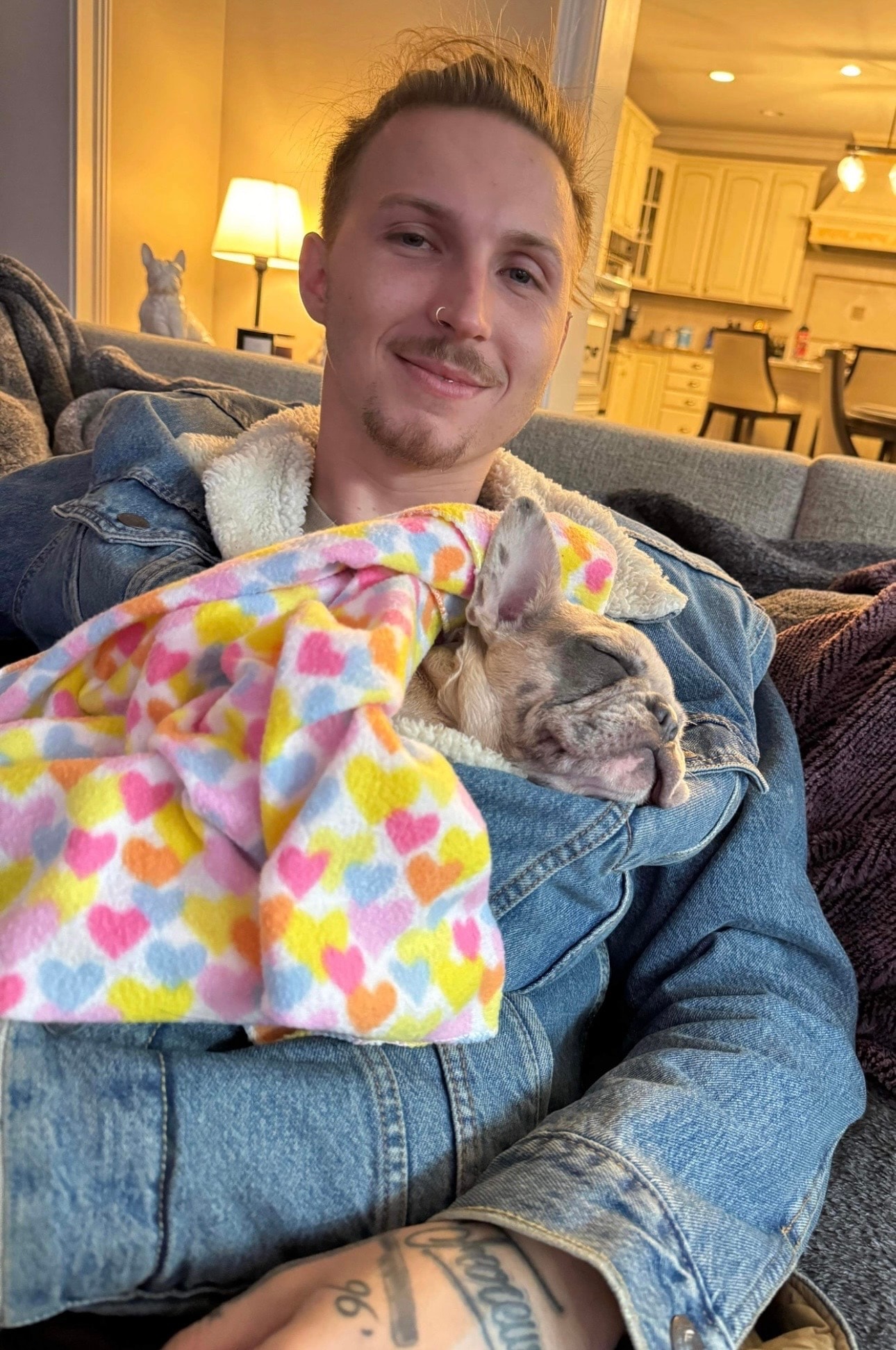 Stone with his puppy wrapped in a blanket