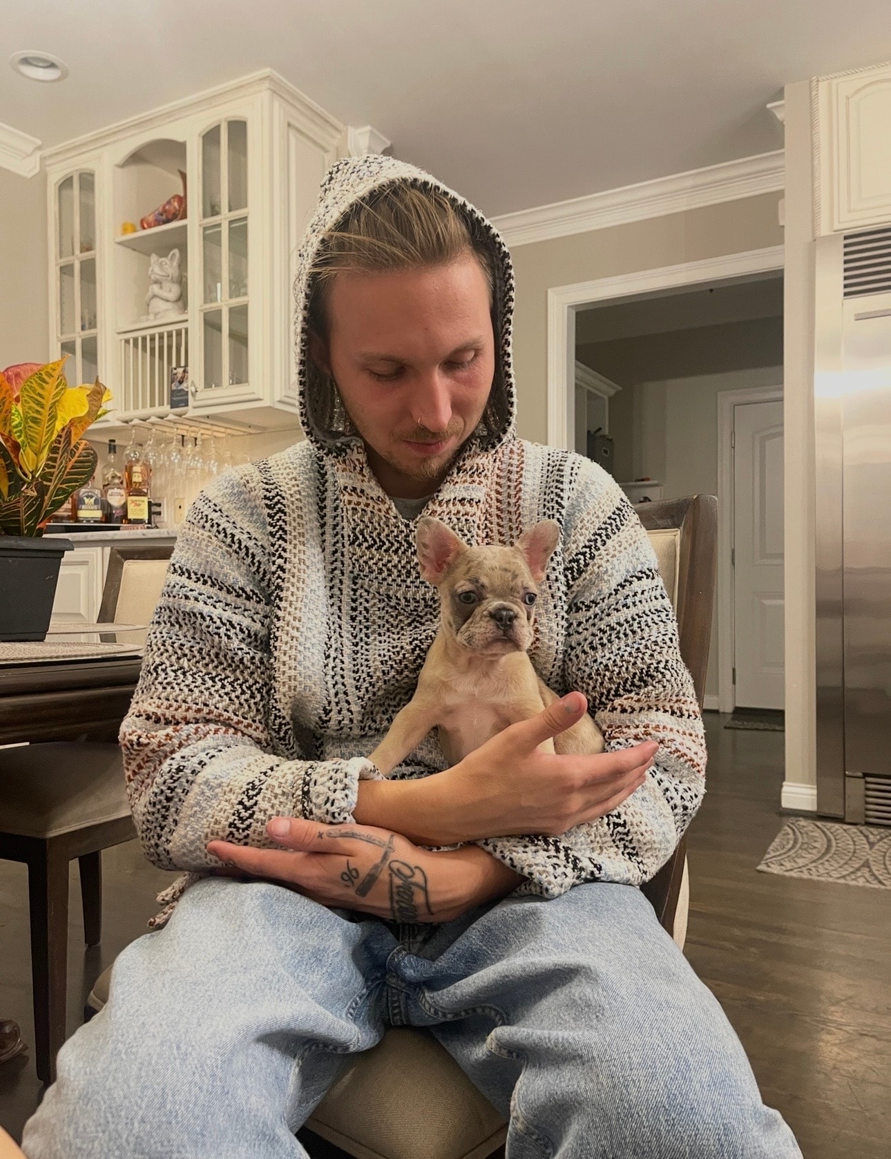 Stone holding his puppy in a hoodie