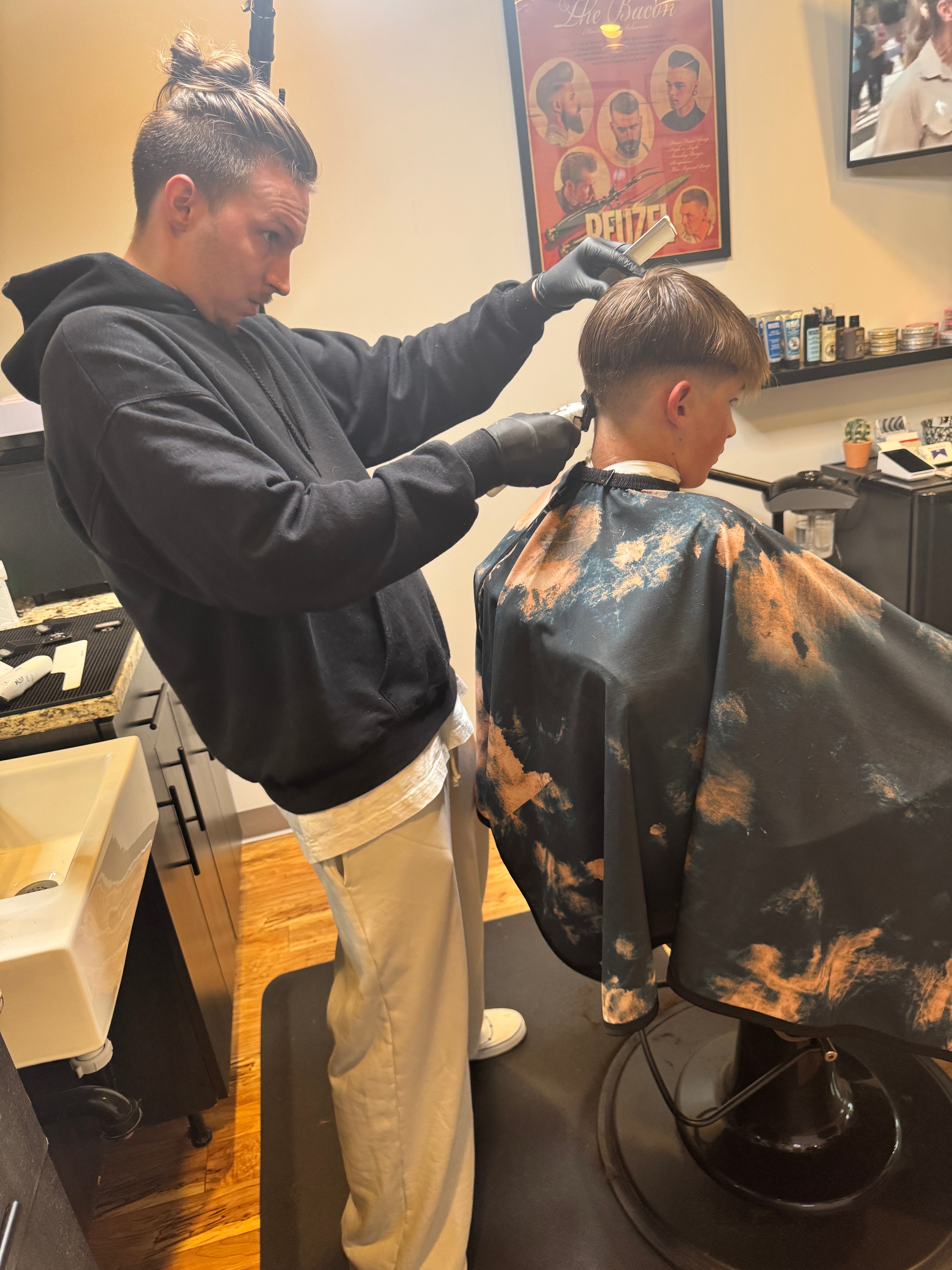 Stone detailing a haircut at Pat's Parlor
