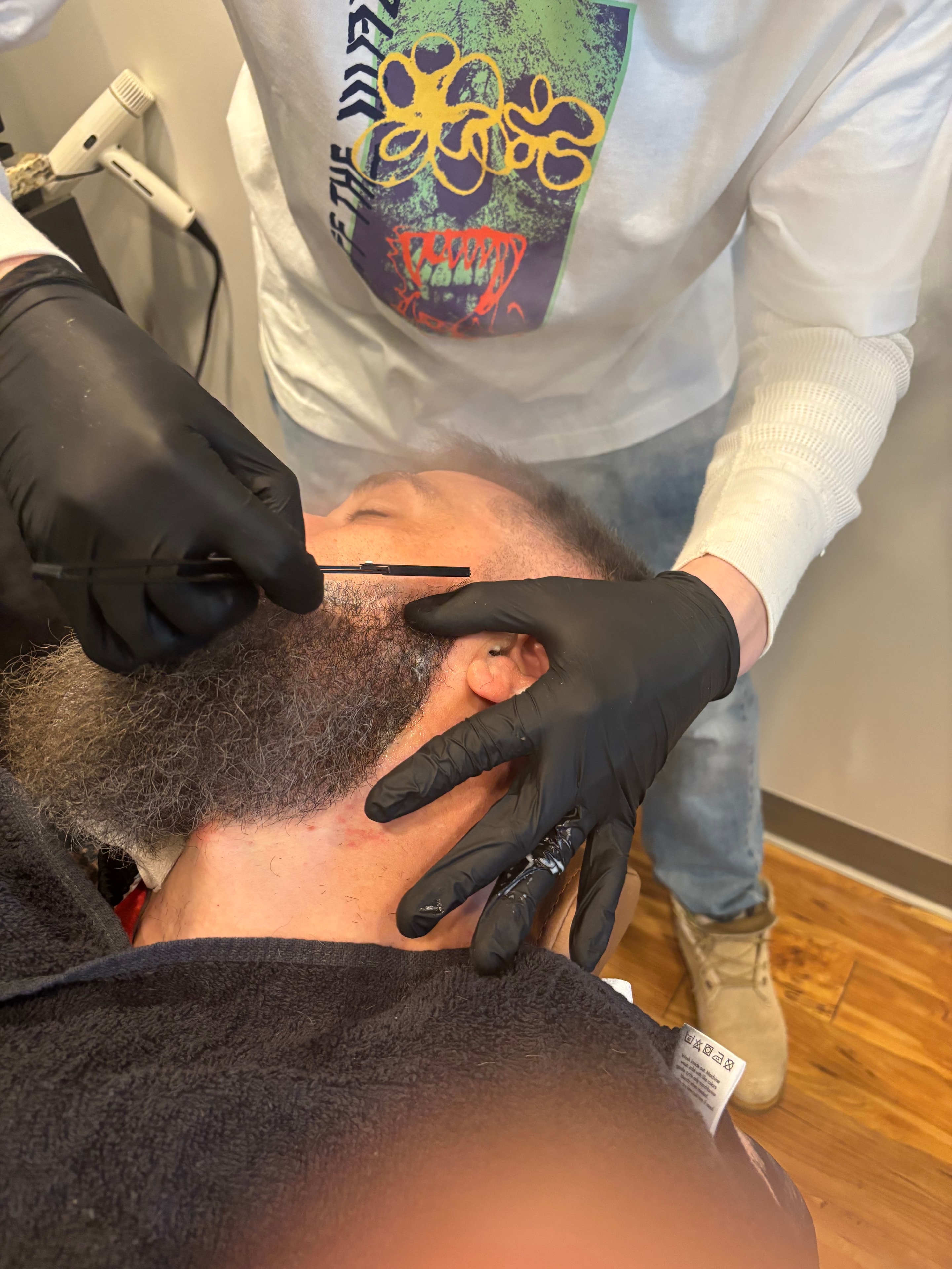 Close up straight razor beard shave at Pat's Parlor & Barber Co